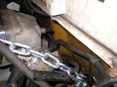 1978 Ford Bronco - Close-up view of engine components and a chain in the engine bay.
