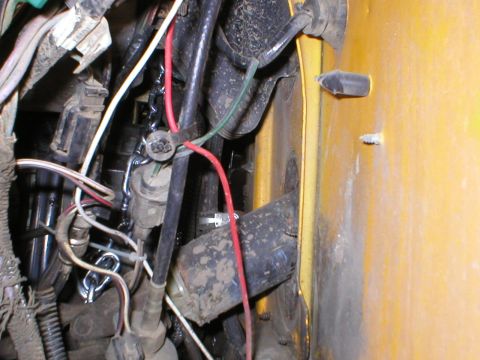 1978 Ford Bronco - Close-up view of complex wiring and components within a vehicle's engine compartment.