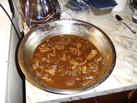 1989 Ford Bronco - A close-up view of a bowl filled with beef jerky sits on a marble countertop, with a spoon and bottle visible in the background.