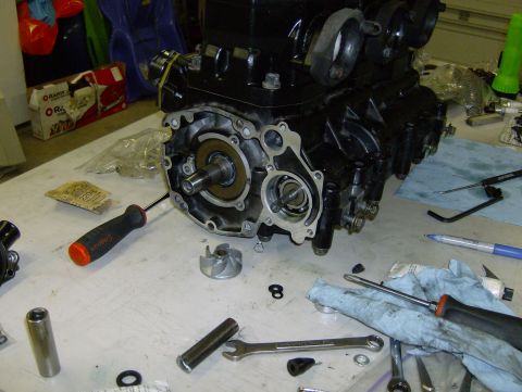 1982 Chevrolet C/K Pickup - Disassembled engine part with tools laid out on a workbench for repair or maintenance.