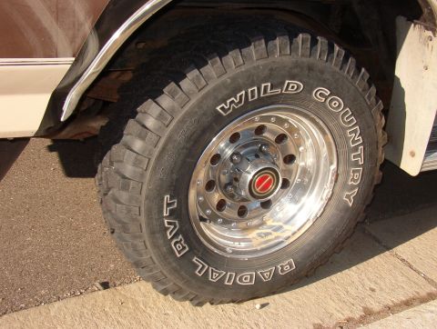 1993 Ford Bronco - Close-up of a 1993 Ford Bronco's front wheel and fender, showing off its Wild Country Radial RVT tires.