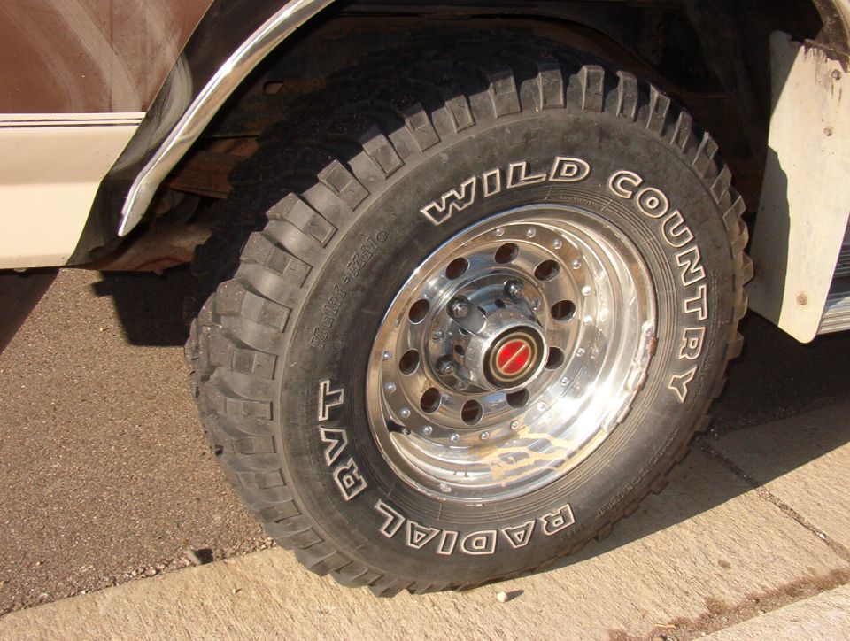 1993 Ford Bronco front wheel with Wild Country Radial RVT tires and chrome rim