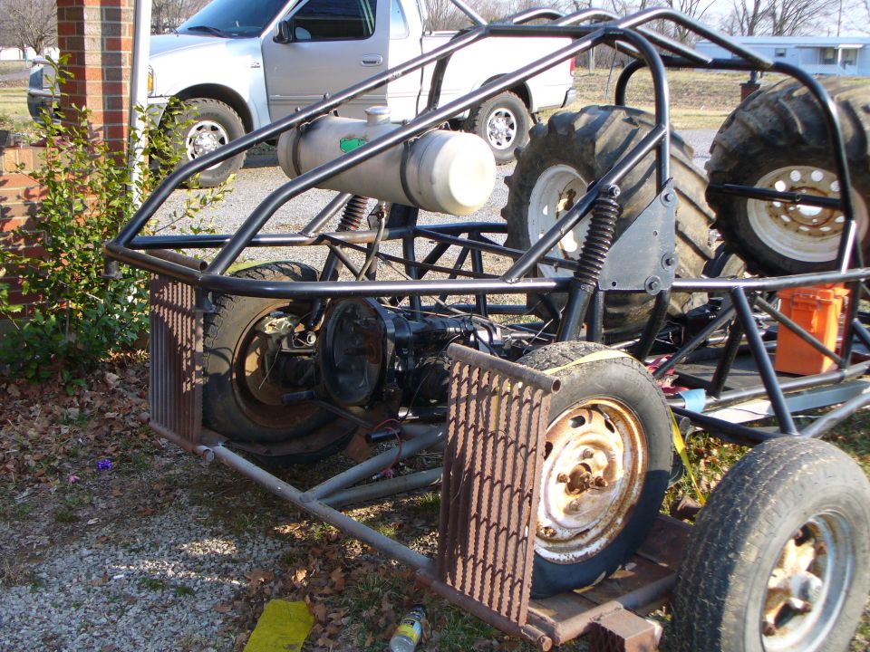 Custom dune buggy chassis with large rear tires and a fuel tank