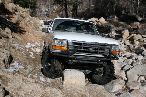 1996 Ford Bronco - This 1996 Ford Bronco is shown traversing a challenging, rocky terrain with scattered snow.
