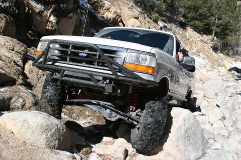 1996 Ford Bronco - This 1996 Ford Bronco is tackling a challenging off-road course on a rocky mountain path.