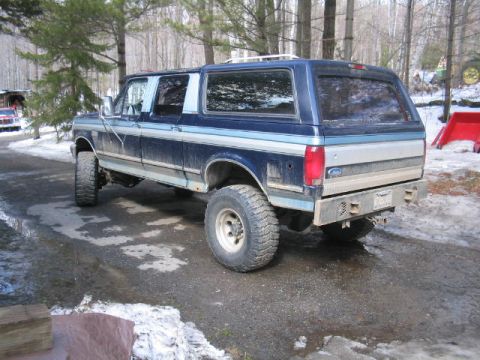 1979 Ford Bronco - This modified Ford SUV, likely an F-Series conversion, sits in a snowy, wooded area.