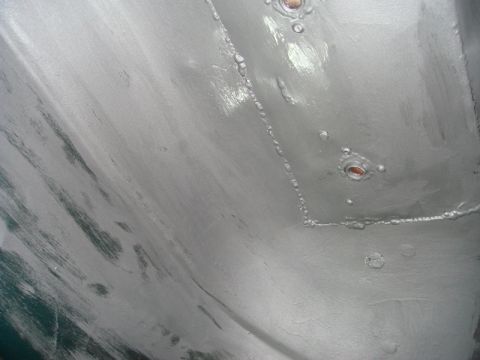 1996 Ford Bronco - Undercarriage repair work showing painted metal and visible rivets.