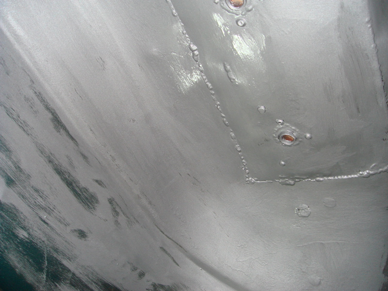 close-up of undercarriage with gray paint and some rivets