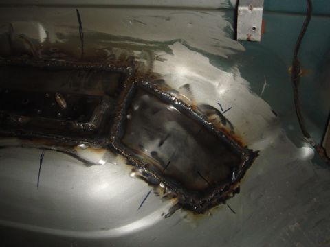 1996 Ford Bronco - Close-up of metal floor repair with extensive welding and some rust evident.