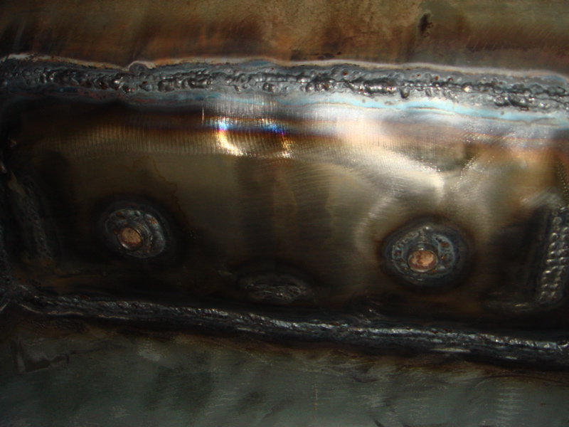 Welded metal with circular fasteners, close-up view