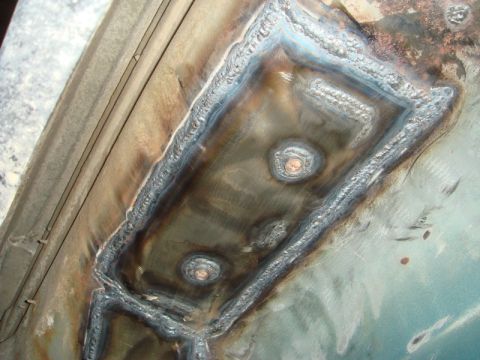 1996 Ford Bronco - Welding repairs completed on the floor pan of a vehicle.