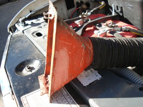 1986 Ford Bronco - The engine bay shows various components, including a battery and a red-painted part with a flexible hose.