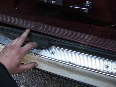 1991 Ford Crown Victoria LTD - Close-up of car door weatherstripping and interior trim.