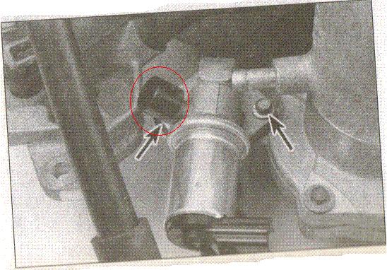 Close-up of engine component with arrows pointing to a circled area