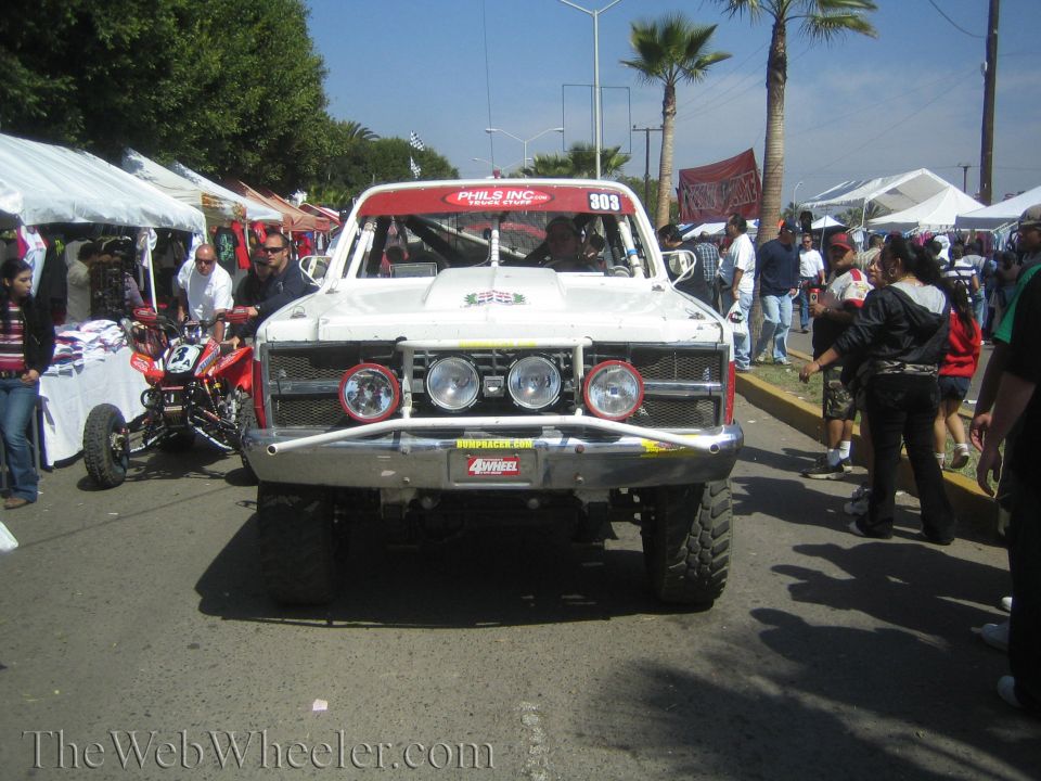 Front of white Phils Inc number 303 off-road race truck with tube bumper