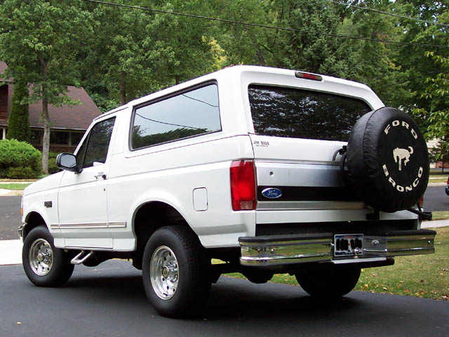 White 1996 Ford Bronco rear view with spare tire cover