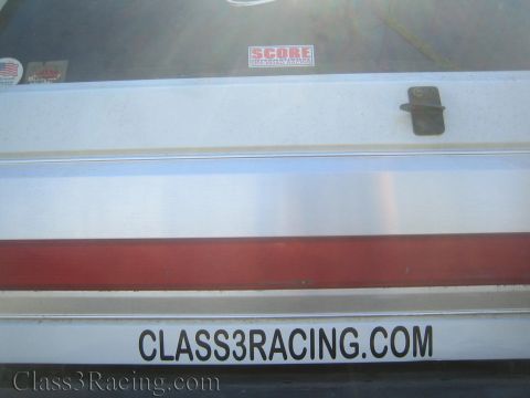 1990 Ford Bronco - Rear body panel of a white vehicle showing a red stripe, a SCORE sticker and Class3Racing.com lettering.