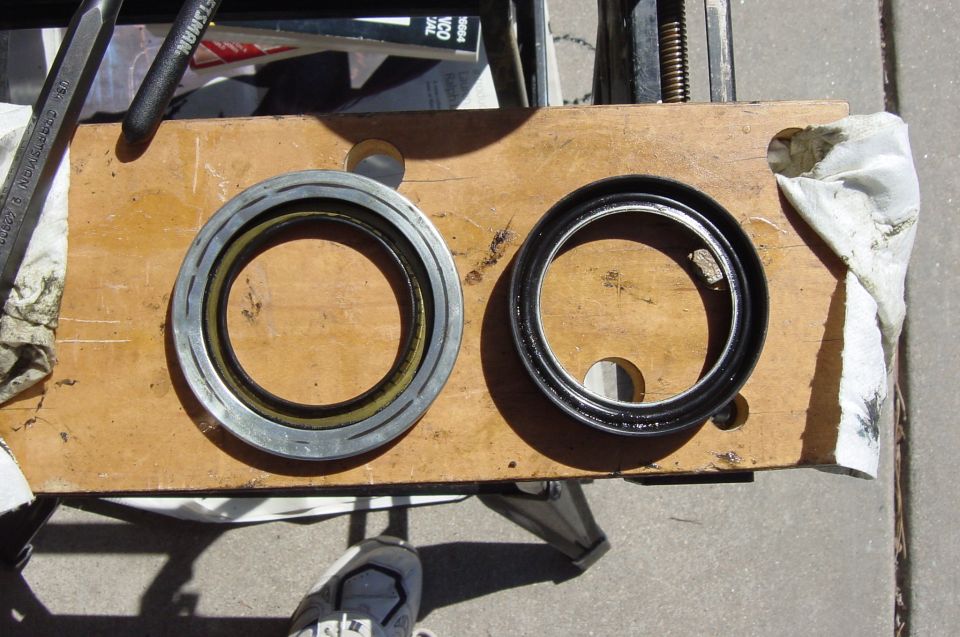 The one on the left shows signs of the where the rubber part of the seal rubbed on the metal making the squeak.
