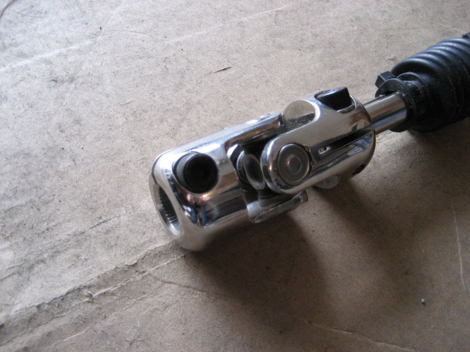 Chrome steering shaft universal joint with black rubber boot