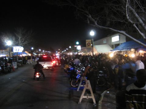 1986 Ford Bronco - A crowded street scene at night with numerous motorcycles and pedestrians, suggesting a festival or event.