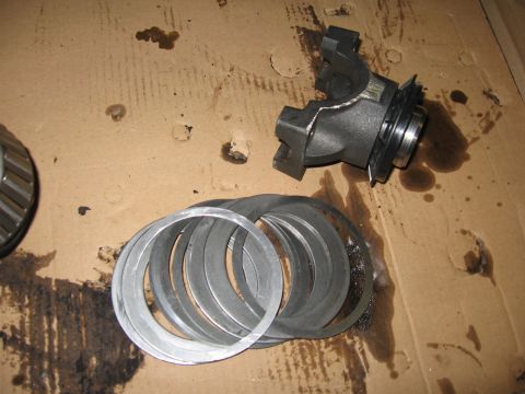 1974 Ford F-100 - Differential carrier and shims are laid out on a stained cardboard surface.