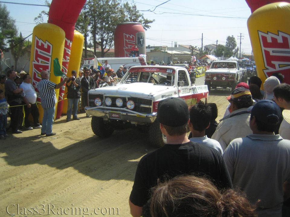 White off-road race truck with BFGoodrich decals on dusty course