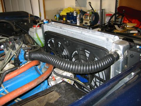 1979 Ford Bronco - Close-up view of an engine bay, highlighting a custom radiator and fan setup with visible hoses and engine components.