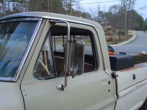 1967 Ford F-250 - A 1967 Ford F-250 pickup truck is seen from the driver's side, showing its exterior details and a toolbox in the bed.