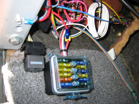 1979 Ford Bronco - The vehicle's electrical system includes a multi-fuse block and several relays, with a tangle of colorful wires.