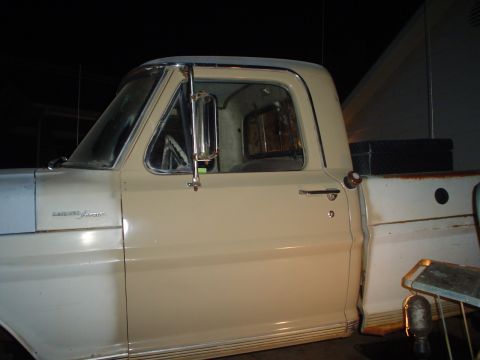 1967 Ford F-250 - The side profile of a 1967 Ford F-250 pickup truck is visible, with a toolbox in the bed.