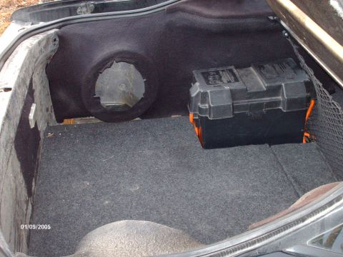 1995 Ford Probe - The trunk of a car contains a battery box and a spare tire well, with a date stamp of 01/09/2005.