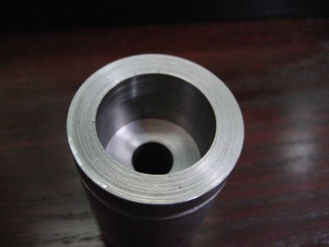 1989 Ford Bronco - A machined metal component is shown in detail, with a visible hole and textured outer edge.