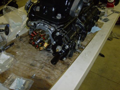 1982 Chevrolet C/K Pickup - Close-up of a black engine component with visible copper wiring, resting on a wooden workbench.