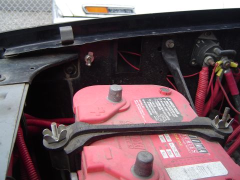 1989 Ford Bronco - The engine bay shows two Optima Red Top batteries secured with a metal bracket and wing nuts, along with red wiring and a toggle switch.