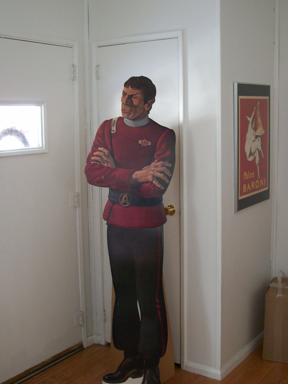 Cardboard cutout of Spock in a red uniform standing in a doorway