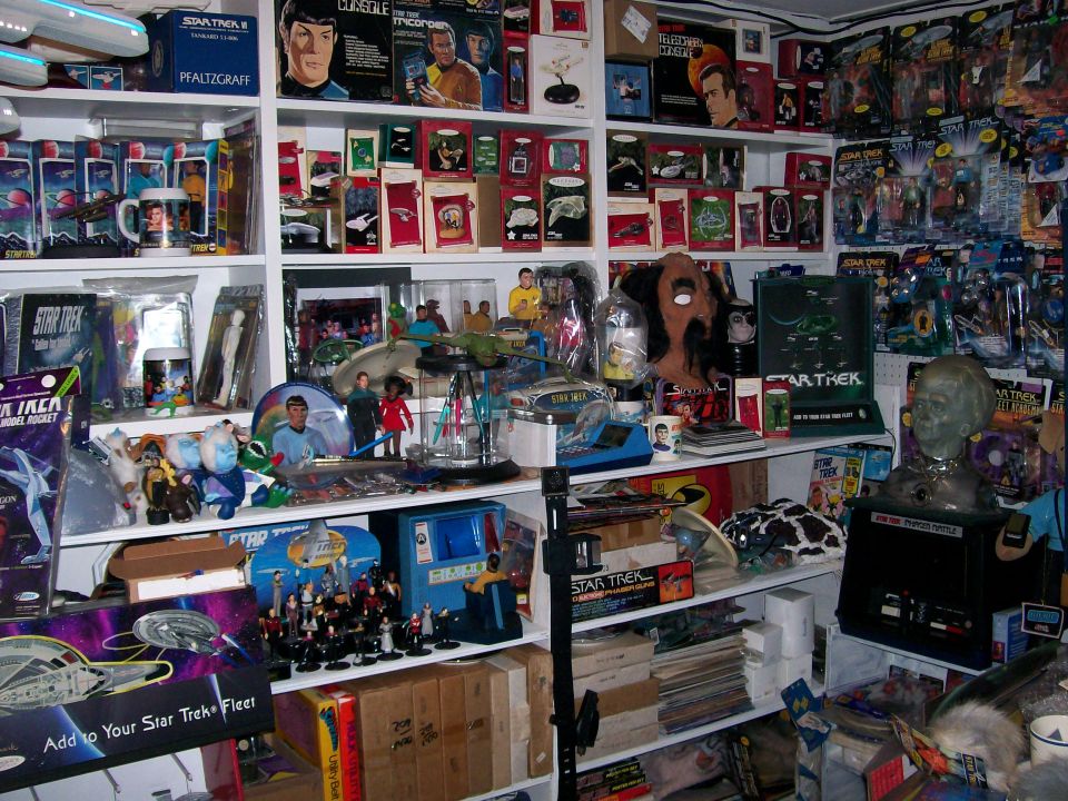 Shelves filled with Star Trek toys, models, and memorabilia