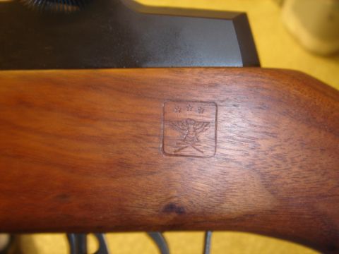 1990 Ford Bronco - Close-up of a wooden stock showing an embossed emblem with a bird and stars.