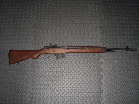 1990 Ford Bronco - Wooden-stocked M14 rifle shown on a textured gray background.