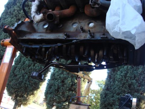 1983 Ford Bronco - after removing a few dozen bolts the oil pan and pan rails were off. the gasket was beat bad----it was way over tighened.
