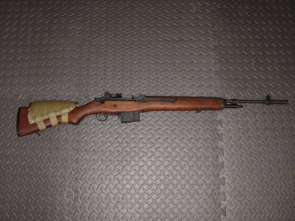 M14 rifle with wooden stock and canvas cheek rest