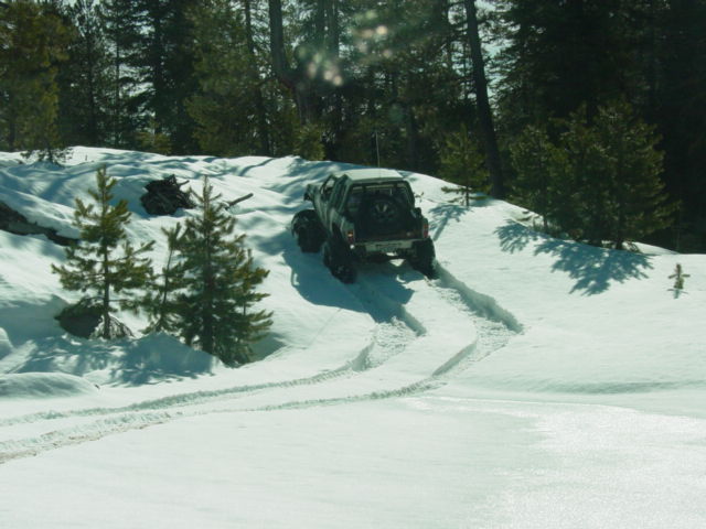 Truck driving up a snowy hill