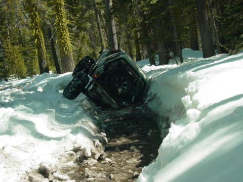 1986 Ford Bronco - This vehicle appears to be stuck in a deep snowdrift on a wooded path.