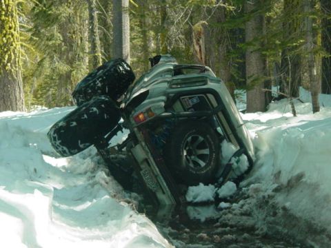1986 Ford Bronco - A 1986 Ford Bronco is stuck deep in the snow in a wooded area.