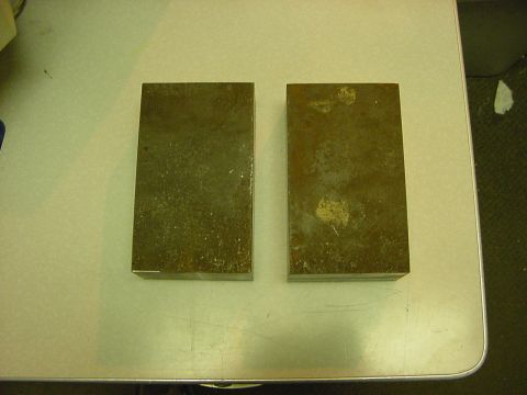 1994 Ford Bronco - Two metal blocks are shown on a table surface.