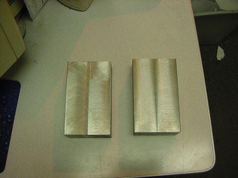 1994 Ford Bronco - Two metal blocks with parallel grooves are shown on a flat surface.