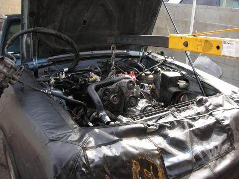 1990 Ford Mustang - Engine removal in progress for a 1990 Ford Mustang, using an engine hoist.