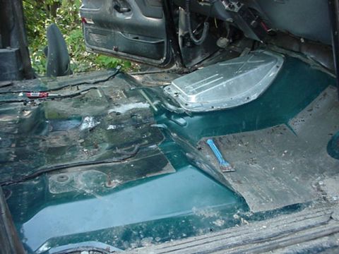 1992 Ford Bronco - all kinds of good junk under there. that stupid tar like junk i peeled up to. its under both seats, under the console, and where the driver…