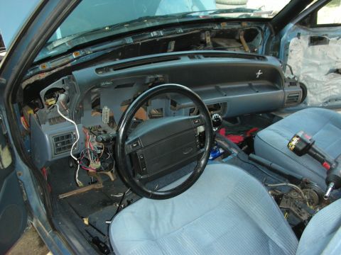 1990 Ford Mustang - Interior of a 1990 Ford Mustang undergoing repairs, with the dashboard disassembled.