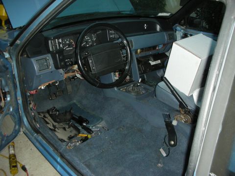 1990 Ford Mustang - Interior of a 1990 Ford Mustang undergoing repairs, showing exposed wiring and dashboard components.