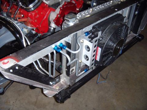 1984 Ford Bronco - Close-up of an engine bay showing a radiator, fan, and associated plumbing with blue fittings.